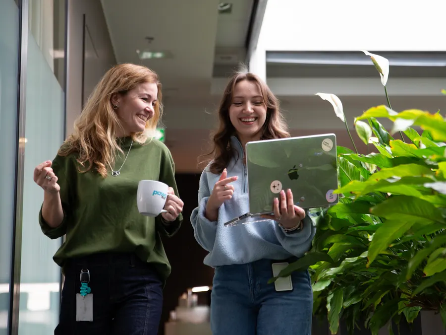 Team members collaborating with technology in green office space