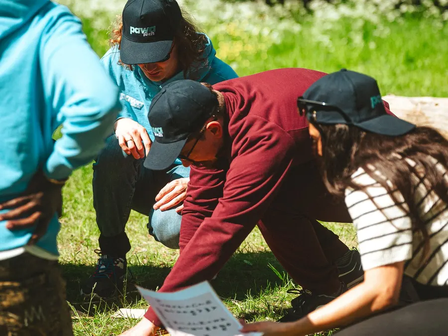 pawaTech team members collaborating outdoors with laptops